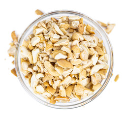 Portion of chopped Cashew nuts isolated on white background (close-up shot)