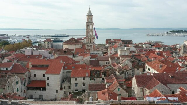 view of iconic bell tower of old town Split Croatia flying bkward over town wall