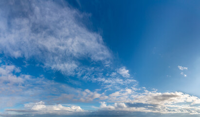 Fantastic clouds against blue sky, panorama