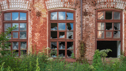 Fototapeta premium broken Windows of an old red brick building.