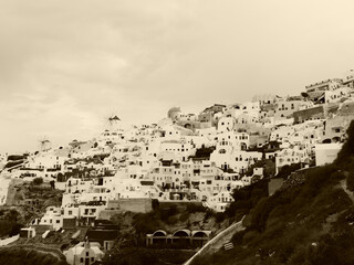 Magic Oia, Sanorini island Greece in sepia. Views of the historical part of the city of Oia. Streets and houses of the old city.