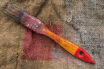 paintbrush on stained jute bag