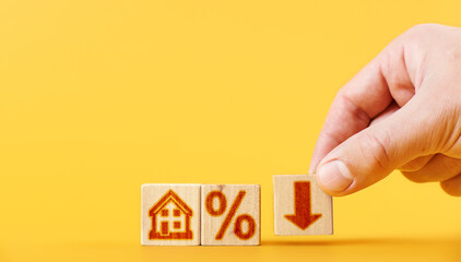 man builds wooden cubes with house and percentage down icons