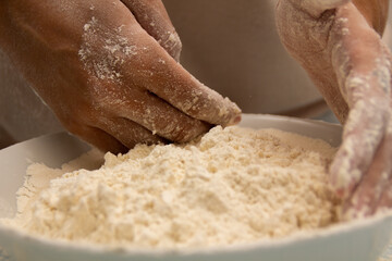 Woman piling flour with her hands