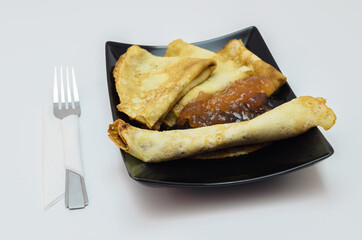 fresh, fried pancakes on a rectangular plate, with apple jam