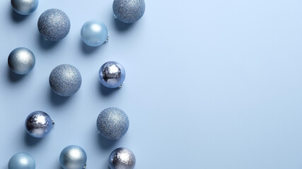 Modern blue Christmas background with glittering balls decorations. Minimal style. Flat lay, top view.