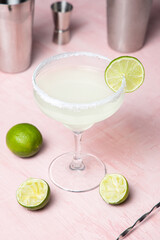 Margarita cocktail with lime wheel in a salt-rimmed glass
