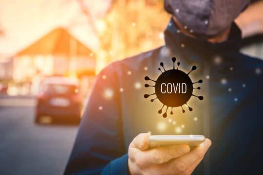 Person read outside news about covid-19 on smart phone