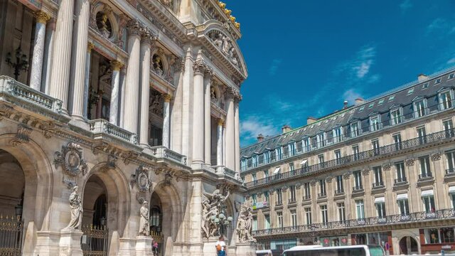 Palais or Opera Garnier The National Academy of Music timelapse in Paris, France. Stairs to the entrance. Blue sky with clouds