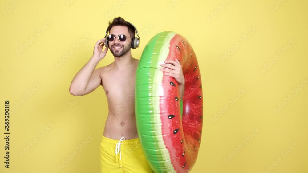 Sticker handsome young man with swimming ring listening to music against color background