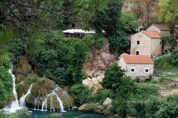 view on an beautiful village encircled by a turquoise river and wilderness