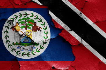 flags of Belize and Trinidad and Tobago painted on cracked wall
