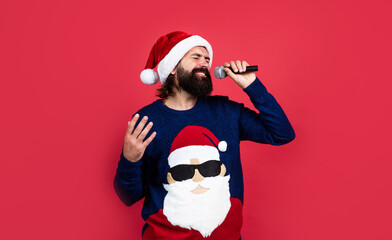 present and gift shopping sale. happy new year. merry christmas. cheerful bearded man in santa claus hat and sweater. brutal hipster celebrate xmas party. winter holiday preparations