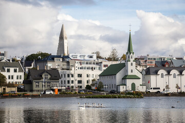 LAKE TJÖRNIN, REYKJAVIK, ICELAND - SEPTEMBER 18, 2018: View of lake Tjörnin and cityscape with...