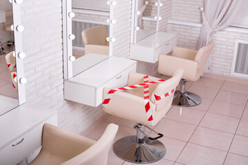 Beauty and hairdressing salon with stylish interior with social distance between working places