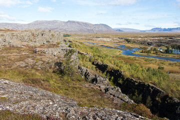 Fototapeta na wymiar THINGVELLIR NATIONAL PARK, ICELAND - SEPTEMBER 19, 2018: Sunny autumn day. The park lies in a rift valley between the North American and Eurasian tectonic plates. Golden Circle in South Iceland.