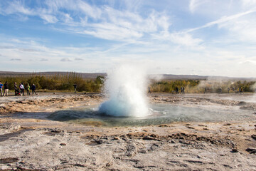 HAUKADALUR, ICELAND - SEPTEMBER 19, 2018: Strokkur erupting. Haukadalur geothermal area is a famous sigth in Iceland, with geysers and other geothermal features.