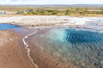 HAUKADALUR, ICELAND - SEPTEMBER 19, 2018: Haukadalur geothermal area is a famous sigth in Iceland, with geysers and other geothermal features including Strokkur, a very powerful and active geyser.