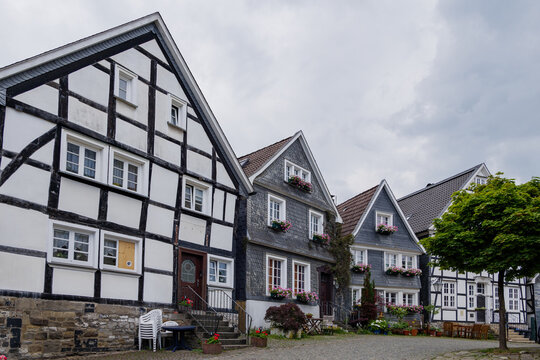 Outdoor street view of small town with traditional German wooden townhouses around Neviges Church in Velbert, Germany.