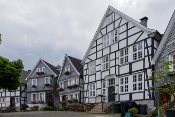 Outdoor street view of small town with traditional German wooden townhouses around Neviges Church in Velbert, Germany.