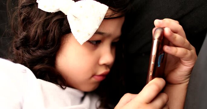 Child absorbed by media content on smartphone. kid hypnotized by social media