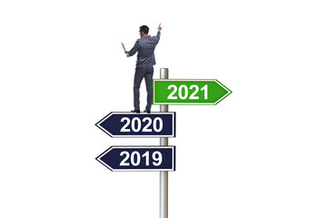 Road sign and businessman with 2020 and 2021