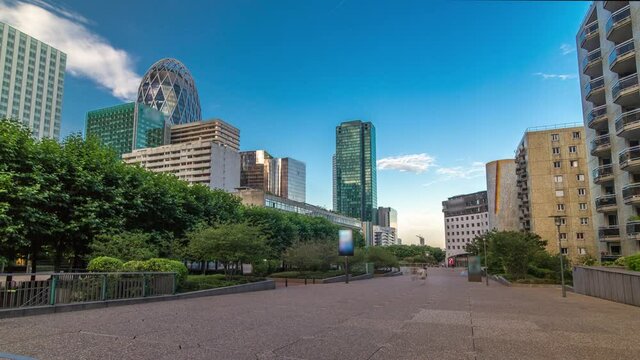 Skyscrapers of La Defense timelapse hyperlapse - Modern business and residential area in the near suburbs of Paris, France. Blue cloudy sky at sunny summer day befire sunset