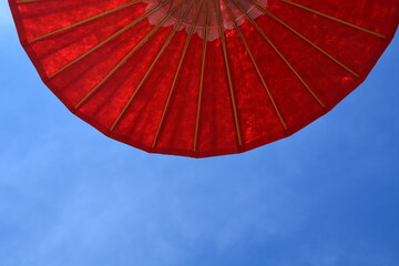 big red umbrella with sky background