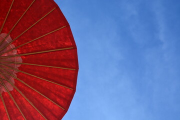 big red umbrella with sky background