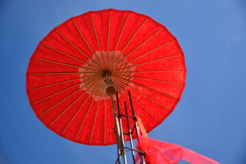 big red umbrella with sky background