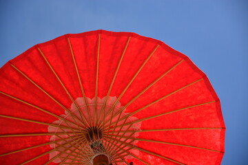 big red umbrella with sky background