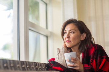Portrait of a mature Asian woman in deep thought.