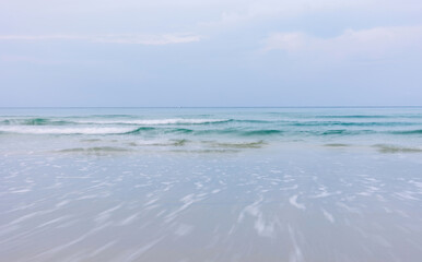 Background. Soft wave of blue ocean on sandy beach.