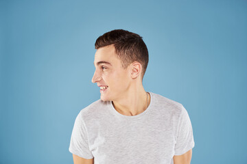 Emotional man in white t-shirt cropped view on blue background lifestyle