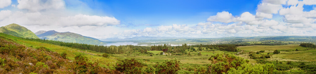 Panoramic view of lough Leane with Ross Island in horizon and the slopes of Mount Mangerton  on a sunny foggy summer morning