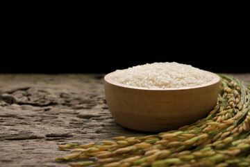 Thai Jasmine rice  (white rice) in wooden bowl and on wooden table.