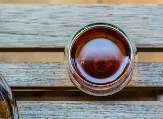A glass cup of tea on wooden table  with light in morning.