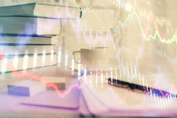 Double exposure of financial chart drawing and desktop with coffee and items on table background. Concept of forex market trading