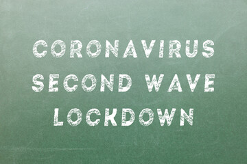 Obraz premium Coronavirus Second Wave Lockdown text on a green board