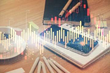 Double exposure of forex chart drawing and cell phone background. Concept of financial trading