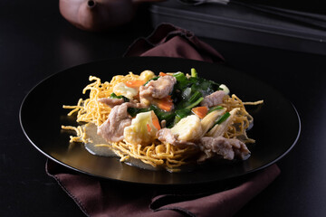 Close-up. Rad Na Noodles, crispy noodles with pork