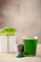 Glass of spirulina drink powder on table. Food and drink, dieting and nutrition concept.