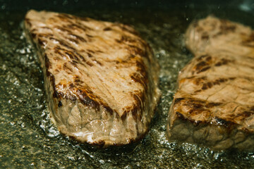 Beef steaks Sizzling in a pan of boiling oil.