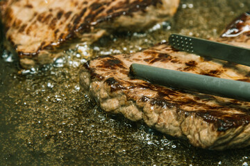 Beef steaks Sizzling in a pan of boiling oil.