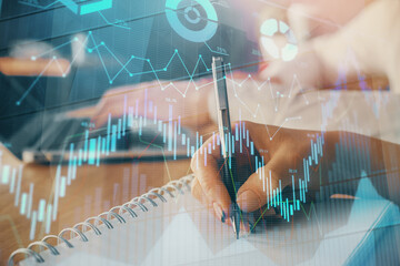 Double exposure of forex chart drawing over people taking notes background. Concept of financial analysis