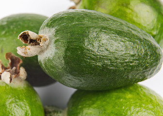 many feijoa fruits are isolated on a white background.