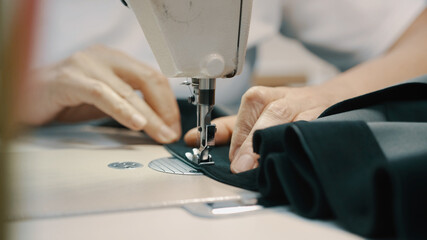 Woman seamstress works at a sewing machine