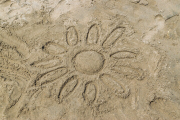 Sun painted on sand in the ocean