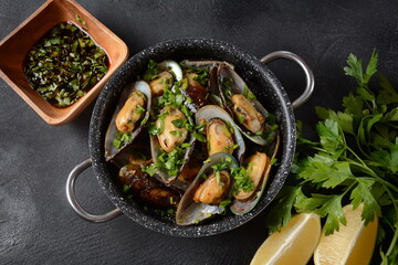 Classic French meal Moules marinière  Marinara mussels with garlic, sauce, lemon and parsley. 