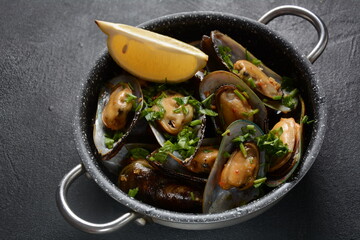 Classic French meal Moules marinière  Marinara mussels with garlic, sauce, lemon and parsley. 